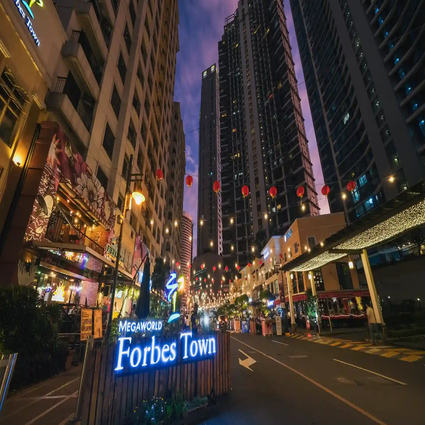 Party bus driving past Forbes Town restaurants and nightlife spots in Makati